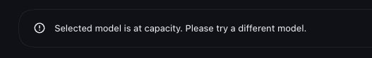 An error line with a warning icon: Selected model is at capacity. Please try a different model.